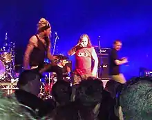 The 2012 incarnation of Pop Will Eat Itself performing live in Birmingham.  Left to right: Davey Bennett (bass), Jason Bowld (drums), Graham Crabb (vocals), Mary Byker (vocals)