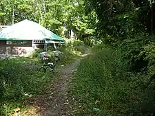 Before paving.  Looking north past Bryn Mawr Park station replica, under Palmer Road, 2007
