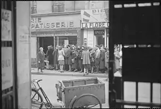 Line outside a Paris bakery in spring 1945. The liberation did not end the food shortages. (Imperial War Museums, U.K.)