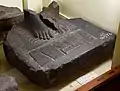 Fragment of the base of a basalt statue dated to the Late Period, the Nine Bows being beneath the feet of the subject of the statue