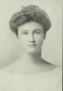 A white woman with dark hair in a bouffant updo