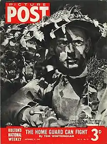 Cover of the Picture Post dated 21 September 1940. Caption: Camouflage – a home guard learns a lesson in cover at Osterley Park Training School