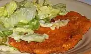 Polish Kotlet z kurczaka Breaded chicken cutlet with cabbage salad.