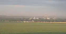 Town with grain elevators; crop field in foreground