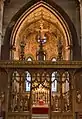 The screen designed by Bodley (1906), who also designed the organ case and reredos