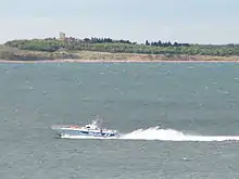 Small police boat on large body of water