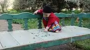 5 Egyptian toddler playing with glass marbles