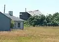Storm-damaged former fire control tower resembling a beach cottage, former Fort Greene south reservation