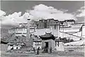 The Potala in 1936 with the village of Zhol at its base and the outer pillar outside the southern entrance.
