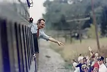 George H. W. Bush waves to spectators along the route of his 1992 campaign whistle stop tour of Ohio