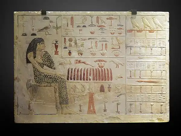 Stele of Princess Nefertiabet eating; 2589-2566 BC; limestone & paint; height: 37.7&nbsp;cm (14.mw-parser-output .frac{white-space:nowrap}.mw-parser-output .frac .num,.mw-parser-output .frac .den{font-size:80%;line-height:0;vertical-align:super}.mw-parser-output .frac .den{vertical-align:sub}.mw-parser-output .sr-only{border:0;clip:rect(0,0,0,0);clip-path:polygon(0px 0px,0px 0px,0px 0px);height:1px;margin:-1px;overflow:hidden;padding:0;position:absolute;width:1px}7⁄8 in.), length: 52.5&nbsp;cm (20.mw-parser-output .frac{white-space:nowrap}.mw-parser-output .frac .num,.mw-parser-output .frac .den{font-size:80%;line-height:0;vertical-align:super}.mw-parser-output .frac .den{vertical-align:sub}.mw-parser-output .sr-only{border:0;clip:rect(0,0,0,0);clip-path:polygon(0px 0px,0px 0px,0px 0px);height:1px;margin:-1px;overflow:hidden;padding:0;position:absolute;width:1px}5⁄8 in.), depth: 8.3&nbsp;cm (3.mw-parser-output .frac{white-space:nowrap}.mw-parser-output .frac .num,.mw-parser-output .frac .den{font-size:80%;line-height:0;vertical-align:super}.mw-parser-output .frac .den{vertical-align:sub}.mw-parser-output .sr-only{border:0;clip:rect(0,0,0,0);clip-path:polygon(0px 0px,0px 0px,0px 0px);height:1px;margin:-1px;overflow:hidden;padding:0;position:absolute;width:1px}1⁄4 in.); from Giza; Louvre (Paris). This finely executed relief represents the most succinct assurance of perpetual offering for the deceased