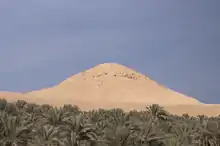 Crumbled remains of a pyramid with the appearance of a mound