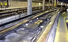 Switches on rubber-tyred metros use conventional points on the standard gauge track to guide trains. Rubber tires, rolling on concrete rollways, keep supporting the full weight of the trains as they go through switches. Guideways are provided in order to ensure there are no gaps in the electrical power supply.