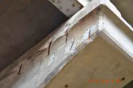 Rusting rebar has expanded and spalled concrete off the surface of this reinforced concrete support