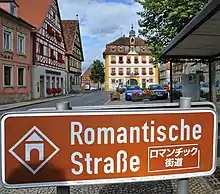Romantic Road sign in southern Germany (note the Alps in the background)