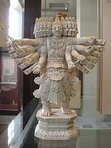 A statue of Ravana with several heads and over a dozen arms