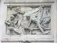 A relatively modern high relief (depicting shipbuilding) in Bishopsgate, London. Note that some elements jut out of the frame of the image.