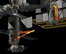 The European Robotic Arm is shown on the left attached to Nauka, the space elbow joint with 2 limbs is shown on the right, attached to Rassvet