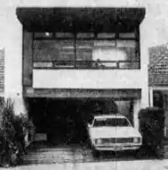 Black and white photo of a two-story building