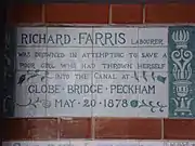 A tablet formed of six standard sized tiles, bordered by green flowers in the style of the Arts and Crafts movement