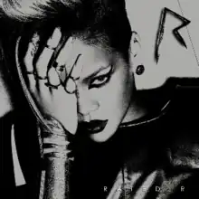 A black-and-white image of a woman wearing a leather jacket. Her hair is side-shaved, wears dark lipstick and her eye is covered with her hand. In the upper right corner there is a metal 'R' sign, while in the bottom right corner the words 'Rated R' are written in white letters.