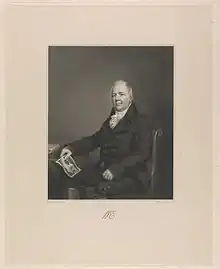Seated engraved portrait of William Esdaile by a table, with a print