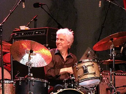 Rieflin smiling while drumming