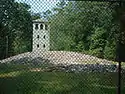mound and observation tower viewed through protective fence