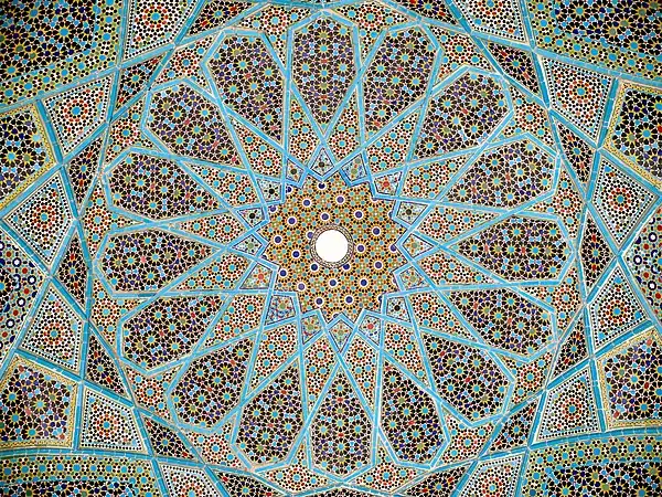 Geometric arabesque tiling on the underside of the dome of Hafiz Shirazi's tomb in Shiraz, Iran