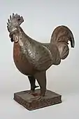 Rooster figure; 18th century; brass; overall: 45.4&nbsp;cm (17.mw-parser-output .frac{white-space:nowrap}.mw-parser-output .frac .num,.mw-parser-output .frac .den{font-size:80%;line-height:0;vertical-align:super}.mw-parser-output .frac .den{vertical-align:sub}.mw-parser-output .sr-only{border:0;clip:rect(0,0,0,0);clip-path:polygon(0px 0px,0px 0px,0px 0px);height:1px;margin:-1px;overflow:hidden;padding:0;position:absolute;width:1px}7⁄8 in.); Metropolitan Museum of Art