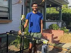 Rory Aronson with the FarmBot Genesis V0.8 prototype in his front yard in San Luis Obispo, California.