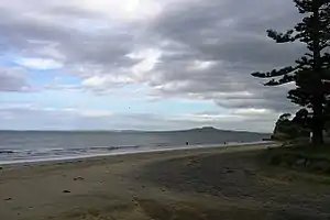 Rothesay Bay Beach with Rangitoto Island in the distance in the Hauraki Gulf