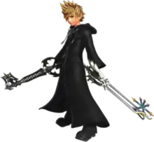 The image shows a young blond-haired blue-eyed kid wearing a black cloak and wielding two key-shaped weapons in his two hands.