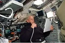 Patrick Forrester talks to ground controllers while on the aft flight deck of Atlantis