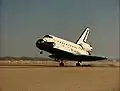 Space Shuttle Atlantis lands on the dry desert lakebed of Edwards Air Force Base at the end of the STS-51-J mission.