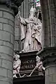 St. Rumbold's statue in St. Rumbold's Cathedral, Mechelen, situated through the arch on the right side.