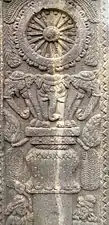 Pillar with elephants supporting a wheel.