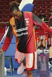 Woman bending forward wearing jersey from Galatasaray