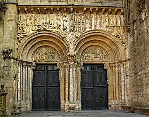 The Porta de Praterías, Cathedral of Santiago de Compostela, by Master Esteban, has two wide openings with tympanums supported on brackets. The sculptured frieze above is protected by an eave on corbels.