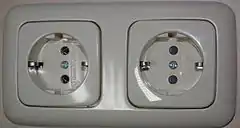 Schuko socket-outlets manufactured by Busch-Jaeger Elektro GmbH, RH socket has protective shutters, LH  does not
