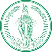 A round seal bearing the image of Indra riding Airavata among clouds, with the words "Krung Thep Maha Nakhon" (in Thai) across the top