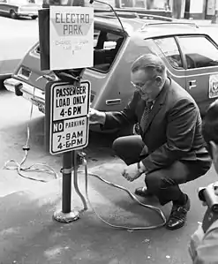 This 1973 photo of a charging station in Seattle shows an AMC Gremlin, modified to take electric power; it had a range of about 50 miles (80&nbsp;km) on one charge.