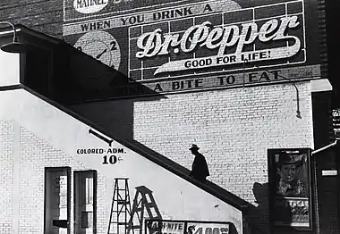 Image 3Racial segregation in the United StatesPhoto: Marion Post Wolcott; Restoration: Lise BroerAn African American man climbs the stairs to a theater's "colored" entrance in Belzoni, Mississippi, in 1939. The door on the ground floor is labeled "white men only". De jure (legally enforced) racial segregation in the United States was eliminated by a series of Supreme Court decisions starting with Brown v. Board of Education in 1954.More selected pictures