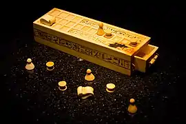 A Senet gameboard and game pieces from the KV62 tomb of Tutankhamun—originally from Thebes.