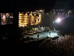 Shakira doing a performance of her song while her fans sing with her.