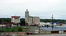 A multi-story building named the "Mill Inn" and tall grain elevator, seen from an elevated vantage point