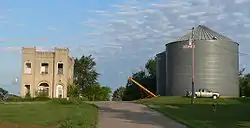 Wayne County Bank building and grain bins in Sholes