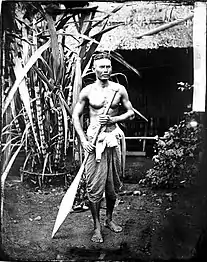 Clothing of Thai boatman, holding an oar