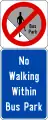 No jaywalking in the bus park