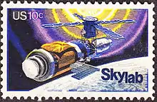 Skylab commemorative stamp, issue of 1974. The commemorative stamp reflects initial repairs to the station, including the parasol sunshade.